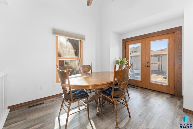 dining area featuring hardwood / wood-style flooring and french doors