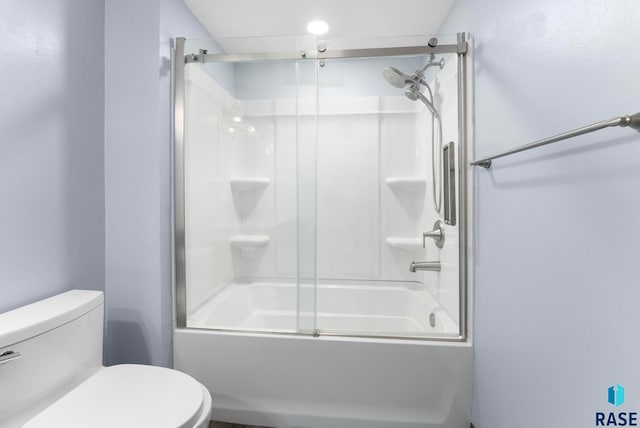 bathroom with enclosed tub / shower combo and toilet