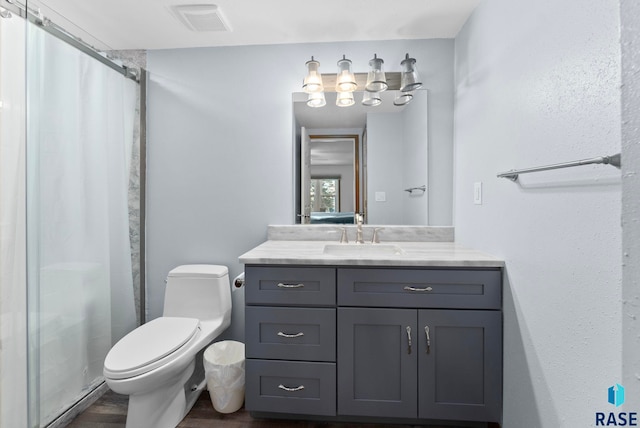 bathroom with walk in shower, vanity, toilet, and hardwood / wood-style flooring