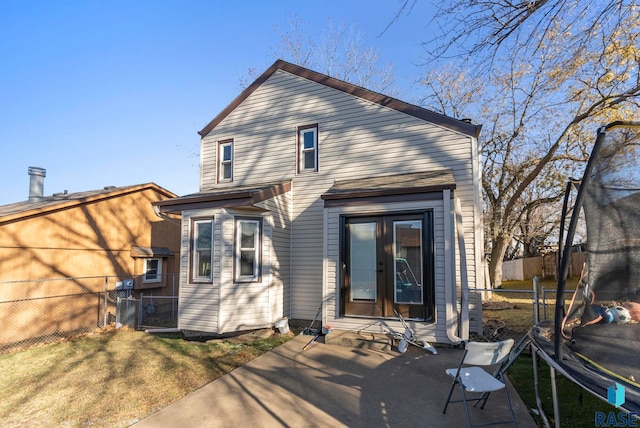 back of house with a trampoline, a patio area, and french doors