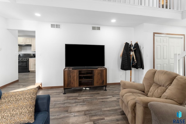 living room with dark hardwood / wood-style flooring