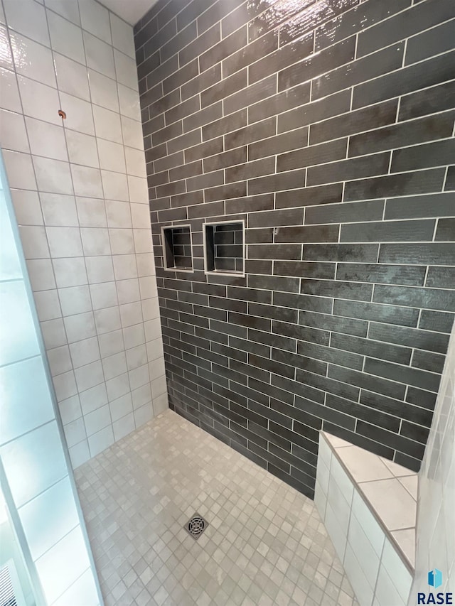 bathroom with tiled shower