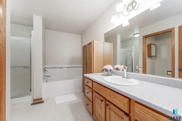 bathroom featuring vanity and independent shower and bath