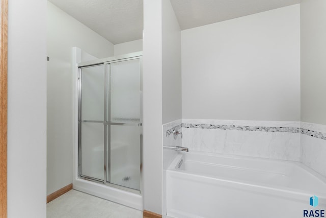 bathroom with a textured ceiling and a bathtub