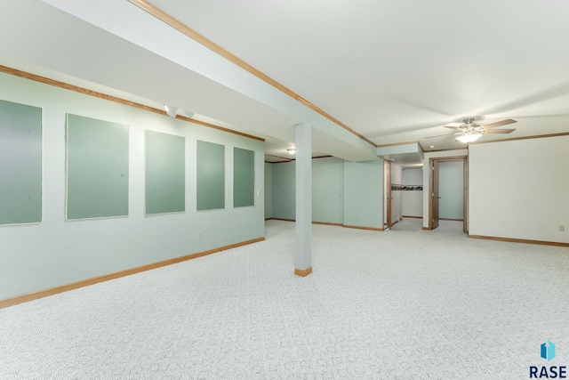 basement with ornamental molding and carpet flooring