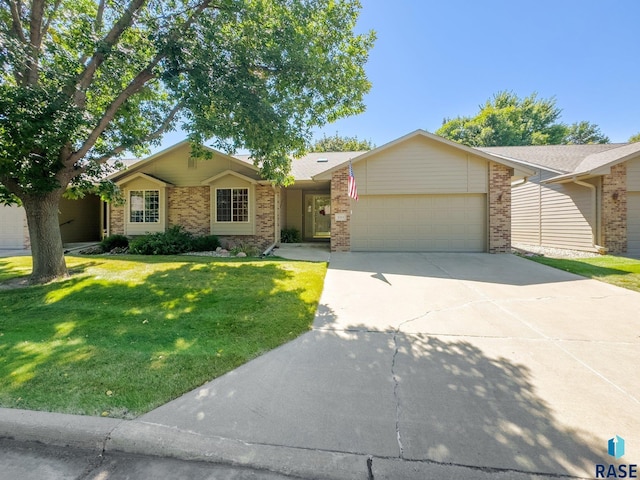 single story home with a garage and a front lawn