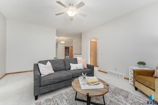 carpeted living room with ceiling fan