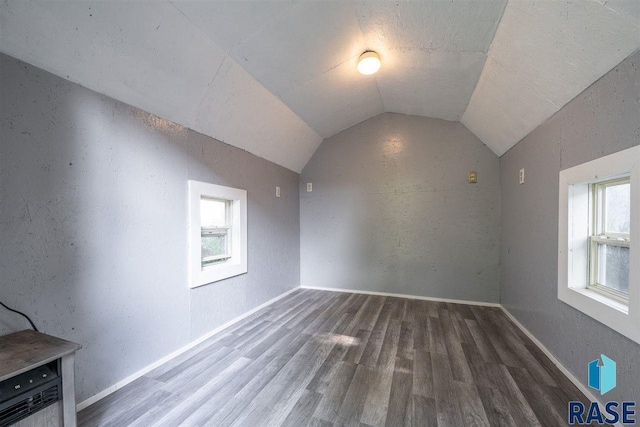 bonus room featuring lofted ceiling and dark hardwood / wood-style flooring