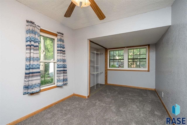 spare room with ceiling fan, carpet floors, and a textured ceiling