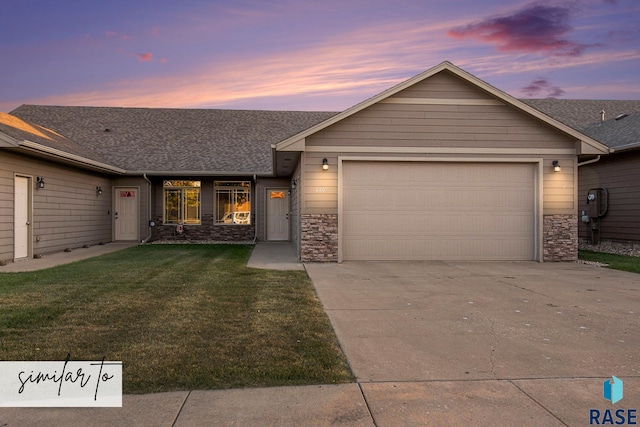 view of front of property featuring a garage and a lawn