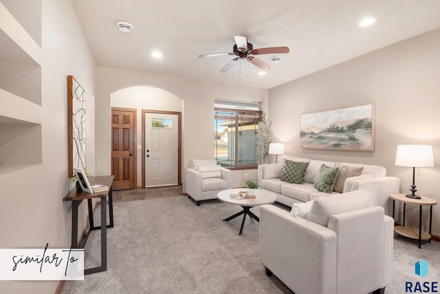 carpeted living room featuring ceiling fan