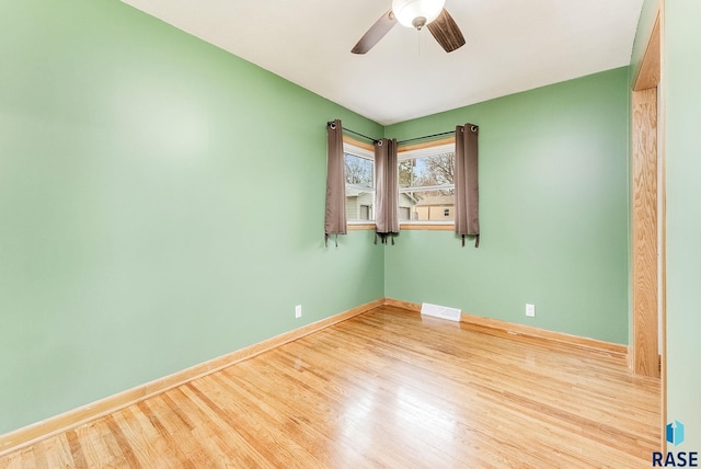 empty room featuring ceiling fan and light wood-type flooring