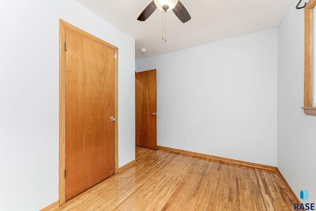 unfurnished bedroom featuring ceiling fan and light wood-type flooring