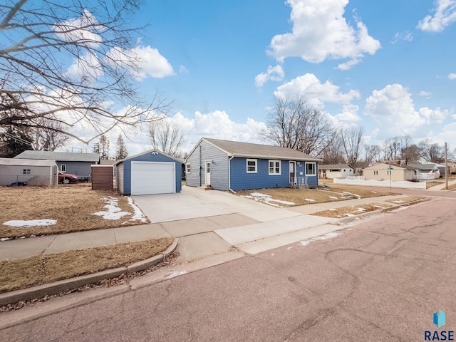 view of front of home with a garage and an outdoor structure