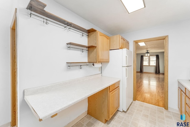 kitchen featuring light brown cabinets, ceiling fan, and white fridge