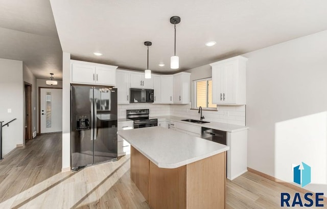 kitchen featuring white cabinetry, sink, black appliances, and a kitchen island