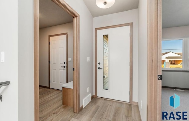 foyer entrance with light hardwood / wood-style floors