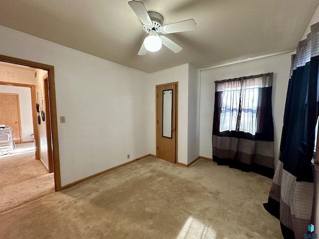 unfurnished bedroom with light colored carpet and ceiling fan