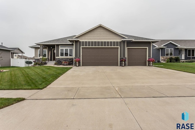 view of front of property featuring a garage and a front yard