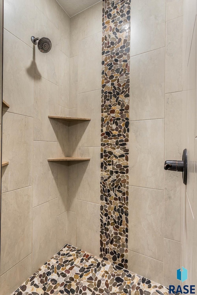 bathroom with a tile shower