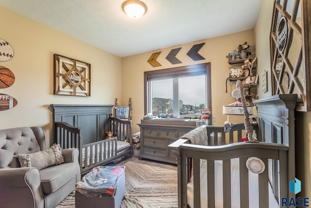 bedroom featuring a nursery area