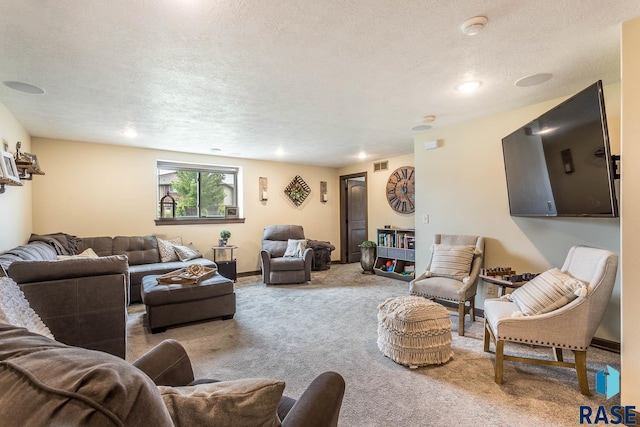 carpeted living room with a textured ceiling