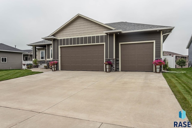 view of front of property with a garage and a front yard