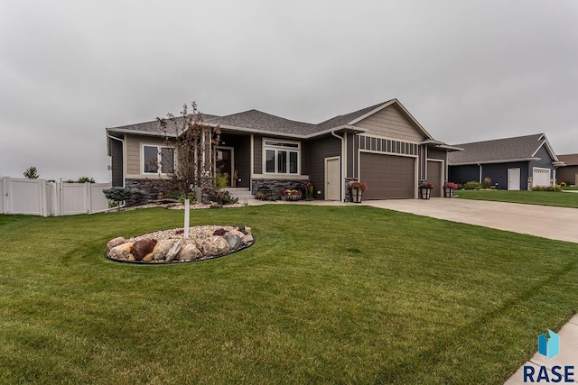 view of front of home featuring a garage and a front lawn