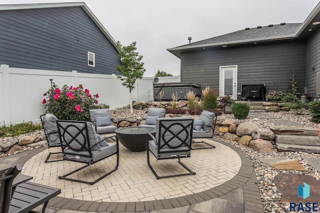 view of patio / terrace with a hot tub