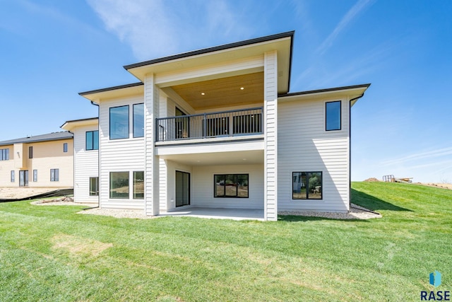 rear view of house featuring a patio and a lawn