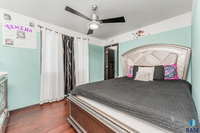 bedroom with dark hardwood / wood-style flooring, a textured ceiling, and ceiling fan