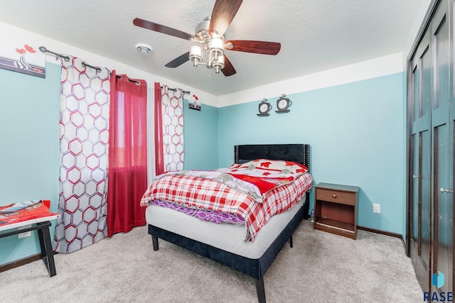 bedroom featuring light carpet, a closet, and ceiling fan