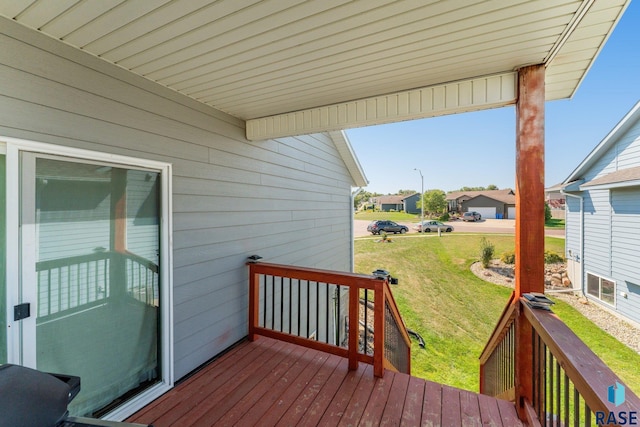 wooden terrace featuring a yard