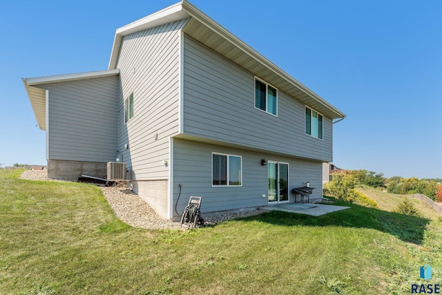 rear view of house with a yard, a patio area, and central air condition unit