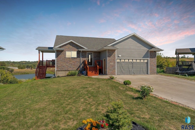 view of front of house featuring a garage and a lawn