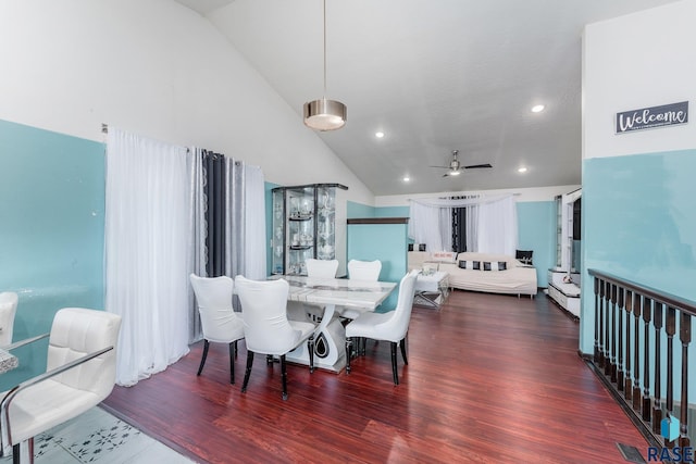 dining area with high vaulted ceiling, dark wood-type flooring, and ceiling fan