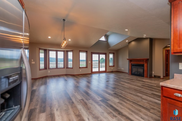 unfurnished living room featuring lofted ceiling and wood-type flooring