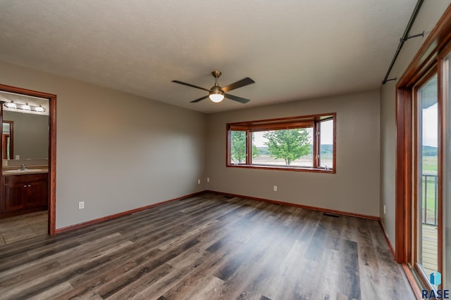 unfurnished room featuring sink, a textured ceiling, wood-type flooring, and ceiling fan