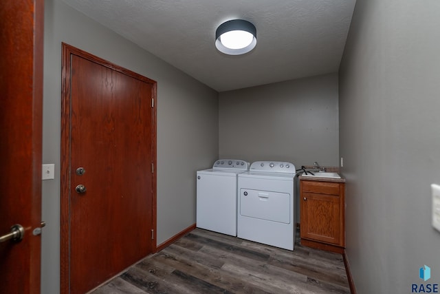 laundry room with dark hardwood / wood-style floors, sink, cabinets, independent washer and dryer, and a textured ceiling