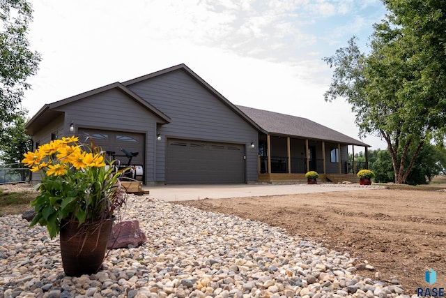 ranch-style house with a garage and a sunroom