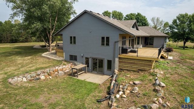 back of property featuring a yard, a patio area, and a deck