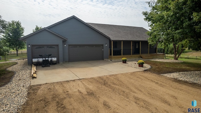 ranch-style home with a garage and a sunroom