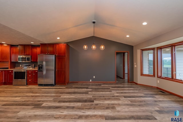 kitchen featuring hardwood / wood-style floors, stainless steel appliances, decorative light fixtures, vaulted ceiling, and a chandelier