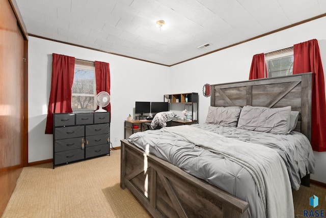 carpeted bedroom with ornamental molding