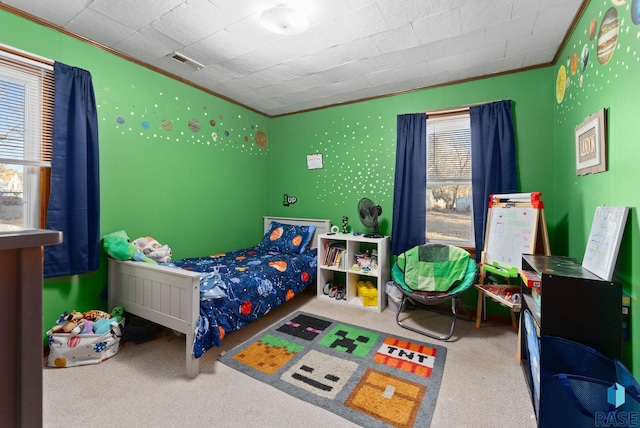 bedroom with ornamental molding and carpet flooring