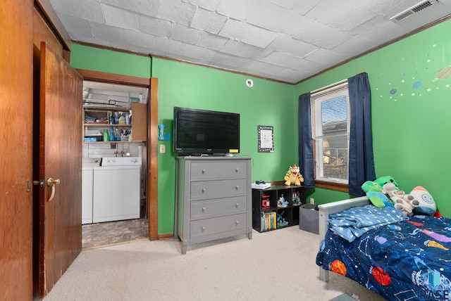 bedroom with ornamental molding, carpet flooring, and separate washer and dryer