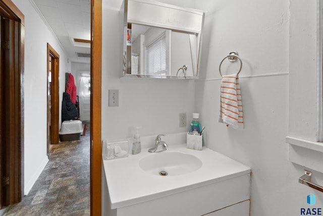 bathroom with crown molding and vanity