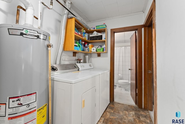 laundry area with crown molding, washer and clothes dryer, and water heater