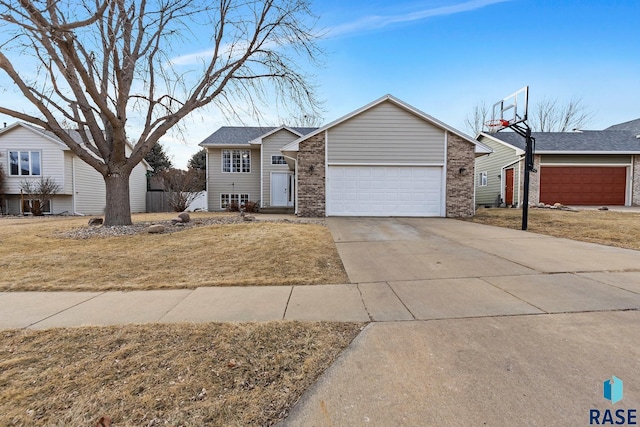 ranch-style house featuring a garage and a front lawn