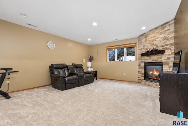 living room featuring a stone fireplace and light carpet